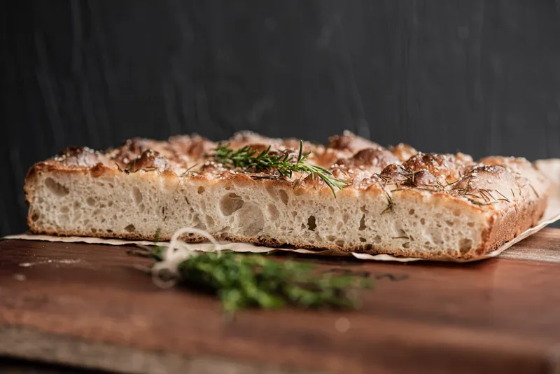 Rosemary focaccia shown in an illustrative food photograph